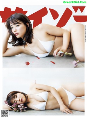 A woman in a white bikini posing for a picture.