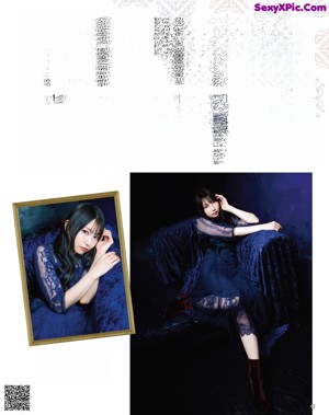 A woman in a blue dress leaning against a blue wall.
