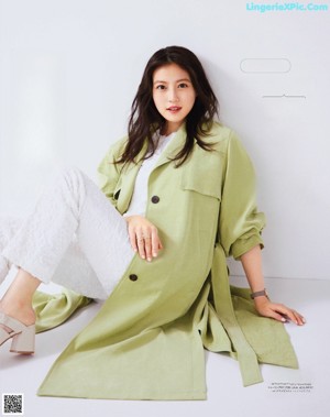 A woman in a yellow skirt and a blue jacket.