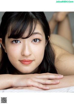 a japanese woman with long black hair is posing for the camera