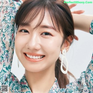 A magazine page with a picture of a woman smiling.