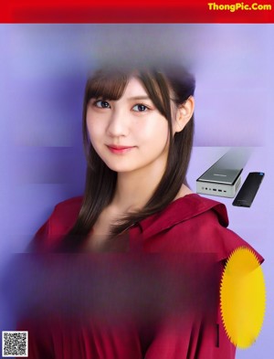 A woman in a red blouse posing for a picture.