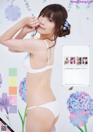 A woman in a bikini with a flower crown on her head.
