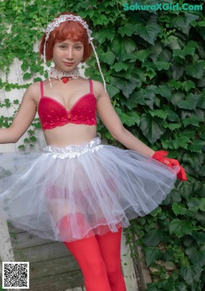 A woman in a red lingerie sitting on a chair.