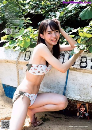 A woman with long black hair is posing for a magazine.