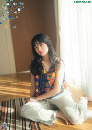 A magazine with a picture of a young woman on the cover.
