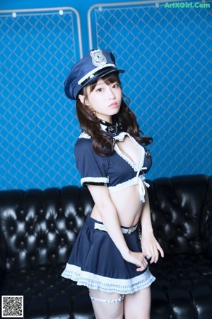 A woman in a police uniform is posing for a picture.